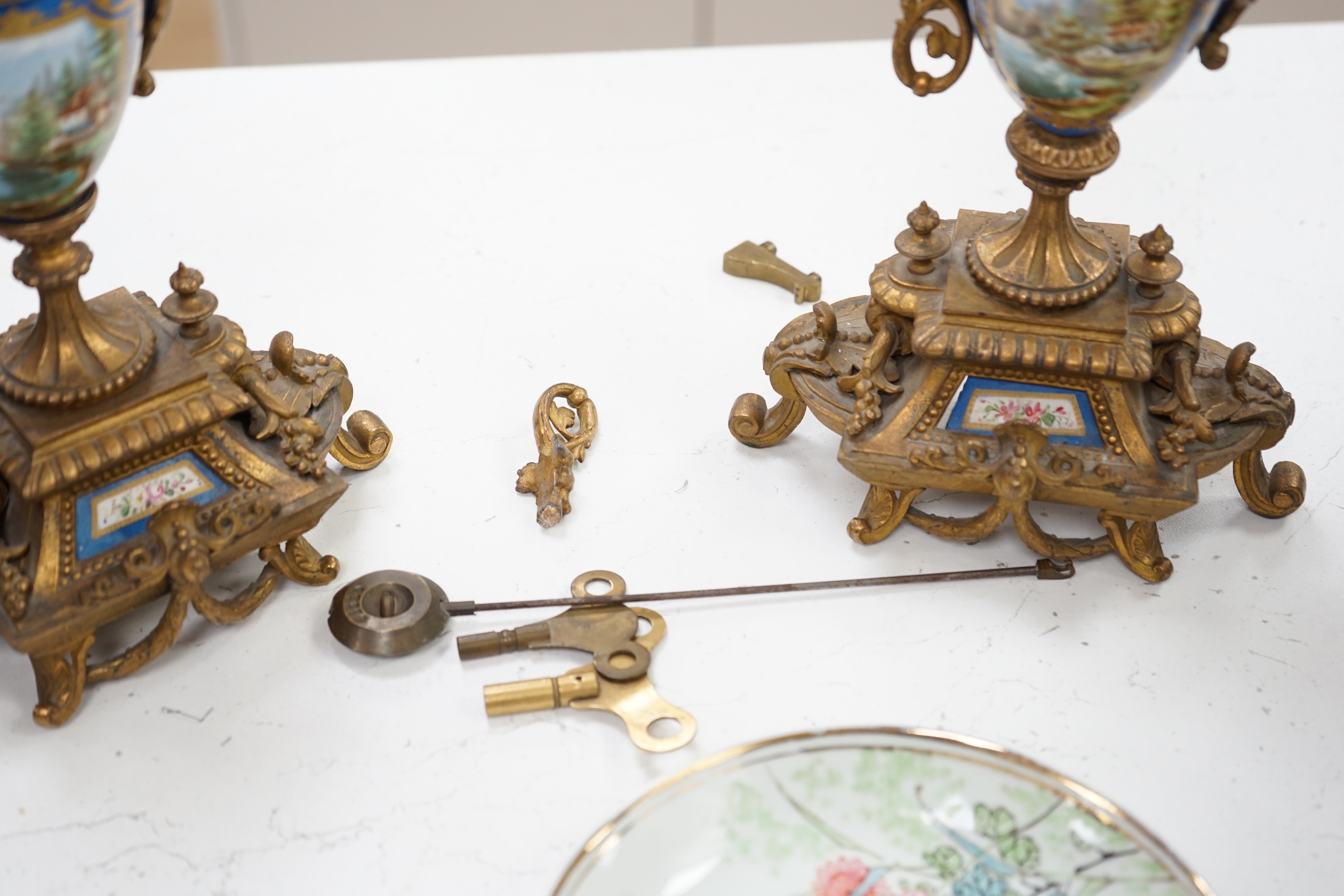 A Sevres style porcelain and gilt metal clock garniture, 44cm high